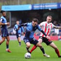 HIGH WYCOMBE, ENGLAND - JANUARY 08: Carl Winchester of Sunderland tackles Josh Scowen of Wycombe Wanderers during the Sky Bet League One match between Wycombe Wanderers and Sunderland at Adams Park on January 08, 2022 in High Wycombe, England. (Photo by Alex Burstow/Getty Images)