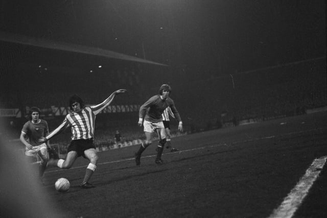 Willie Donachie, left, and Colin Bell of Manchester City look on as Sunderland forward Billy Hughes crashes home his side's second goal.