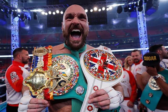 Tyson Fury v Dillian Whyte - WBC World Heavyweight Title - Wembley Stadium, London, Britain - April 23, 2022  Tyson Fury celebrates with the belts after winning his fight against Dillian Whyte Action Images via Reuters/Andrew Couldridge