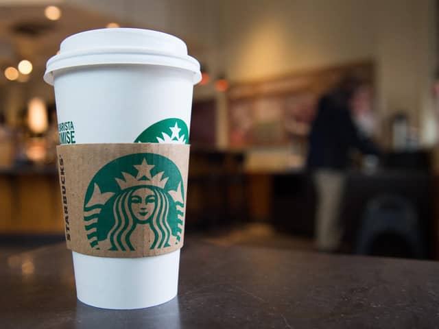 A Starbucks coffee cup (Photo by SAUL LOEB/AFP via Getty Images)