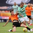 Patryk Klimala of Celtic is tackled by Jamie Robson of Dundee United.