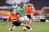 Patryk Klimala of Celtic is tackled by Jamie Robson of Dundee United.