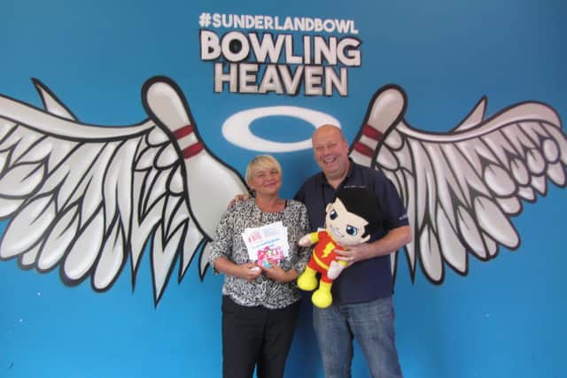 Karen Noble accepts gifts from Brian Smith of Sunderland Bowl on behalf of the Pallion Action Group.