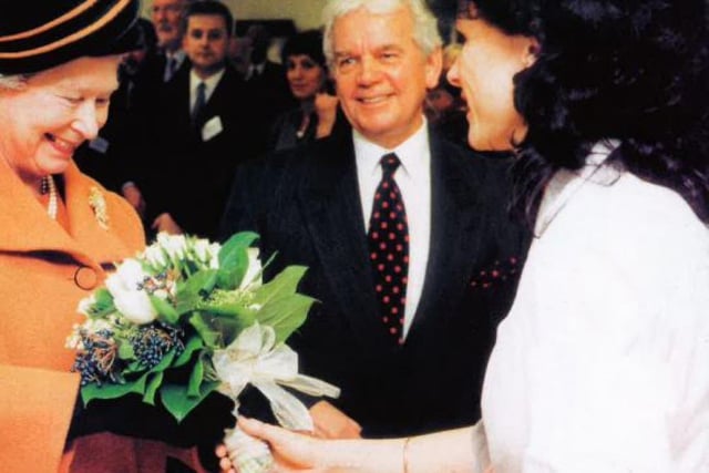 Chiropody Services Manager Mary Spearman presents a bouquet to Her Majesty.