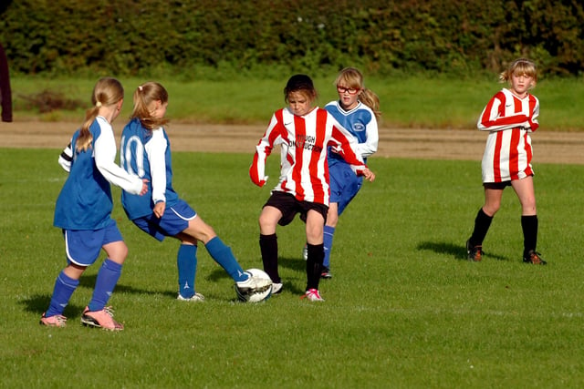 Barnes Angels under 11's (red/white) get a tackle in against Newton Aycliffe YC.