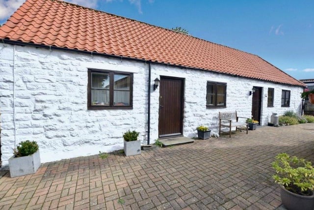 The property includes a detached holiday cottage.