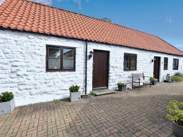 The property includes a detached holiday cottage.