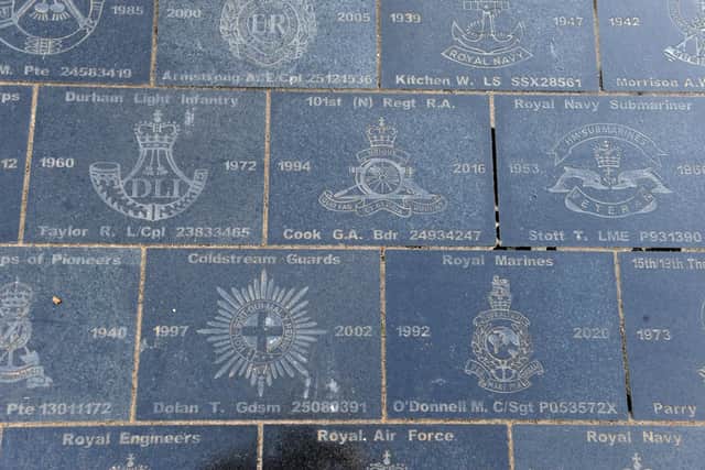 Granite slabs are engraved with names, regimental badges and years of service