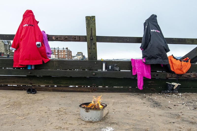 Isabella and Maree leave their dry robes hanging up - and their fire pit burning - ready for them coming out of the water.