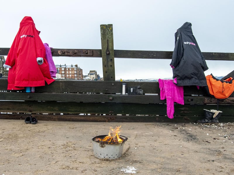 Isabella and Maree leave their dry robes hanging up - and their fire pit burning - ready for them coming out of the water.