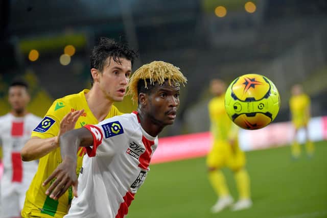 Nantes' French defender Sebastien Corchia (L) fights for the ball with Dijon's Gabonese midfielder Didier Ndong during the French L1 football match between FC Nantes and Dijon at the La Beaujoire Stadium in Nantes, western France, on December 13, 2020. (Photo by LOIC VENANCE / AFP) (Photo by LOIC VENANCE/AFP via Getty Images)