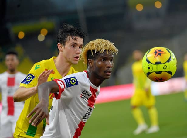 Nantes' French defender Sebastien Corchia (L) fights for the ball with Dijon's Gabonese midfielder Didier Ndong during the French L1 football match between FC Nantes and Dijon at the La Beaujoire Stadium in Nantes, western France, on December 13, 2020. (Photo by LOIC VENANCE / AFP) (Photo by LOIC VENANCE/AFP via Getty Images)