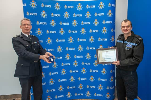 The success of Operation Santa Paws caps off a memorable year for Southwick-based cop PC Baker, who recently received a British Citizen Award in recognition for his services to the community. PC Baker is pictured with Chief Constable Winton Keenen.