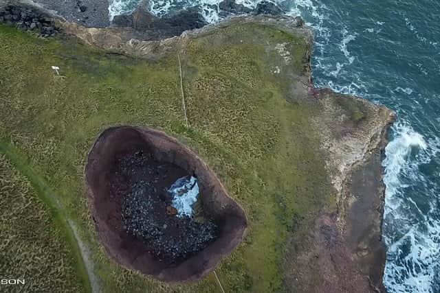The beach formed at the bottom of the sinkhole is captured by Davy Robson.