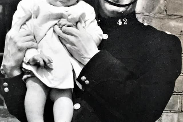 PC Bill Ford holding his son George.