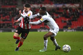 SUNDERLAND, ENGLAND - DECEMBER 11: Sunderland player Leon Dajaku (l) is challenged by Plymouth player Jordon Garrick during the Sky Bet League One match between Sunderland and Plymouth Argyle at Stadium of Light on December 11, 2021 in Sunderland, England. (Photo by Stu Forster/Getty Images)
