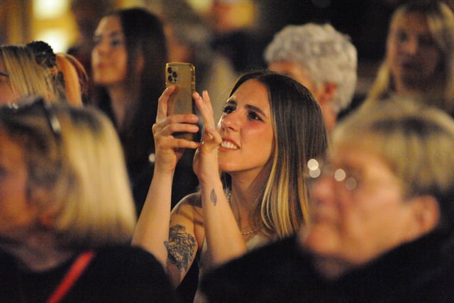 An audience member captures the moment.
