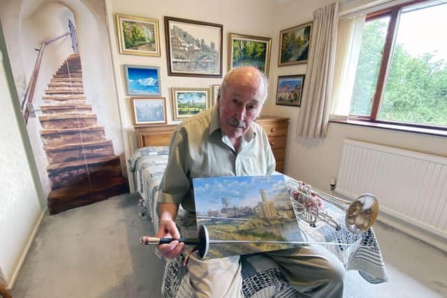 Clive Madgin, originally from Ryhope, can fence, paint and play the trumpet; although not at the same time. He's holding one of his paintings of Wearmouth Colliery.