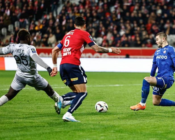Lille's French goalkeeper Lucas Chevalier (R) stops the ball in front of Clermont-Ferrand's French forward Grejohn Kyei (L) during the French L1 football match between Lille LOSC and Clermont Foot 63 at Pierre-Mauroy stadium in Villeneuve-d'Ascq, northern France on February 1, 2023. (Photo by Sameer Al-DOUMY / AFP) (Photo by SAMEER AL-DOUMY/AFP via Getty Images)