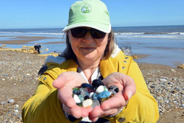 Seaham sea glass collector Paula Newman with her latest find of glass on Seaham Hall Beach.