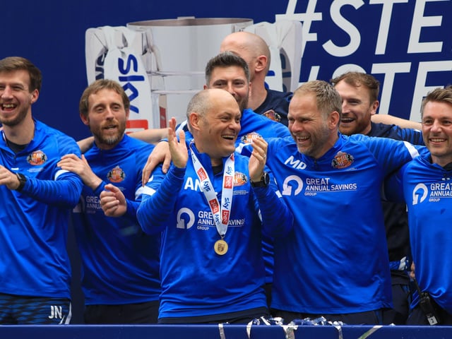 Alex Neil and hos coaching staff celebrate the Wembley win
