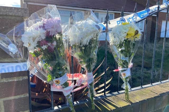 Floral tributes outside a property at Tunstall Village Green, Sunderland, where human remains were found.