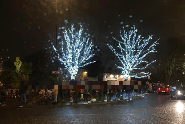 Crowds were attending a charity event where they could visit Santa through a pub window.