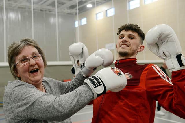 Sunderland AFC defender Tom Flanagan receives a blow to the chin from Mary Eggleston during the EFL Day of Action held at the Beacon of Light.