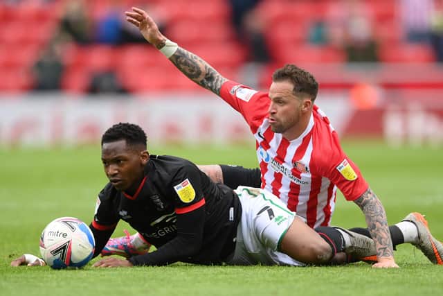 SUNDERLAND, ENGLAND - MAY 22: Sunderland player Chris Maguire (r) challenges Tayo Edun of Lincoln during the Sky Bet League One Play-off Semi Final 2nd Leg match between Sunderland and Lincoln City  at Stadium of Light on May 22, 2021 in Sunderland, England. (Photo by Stu Forster/Getty Images)