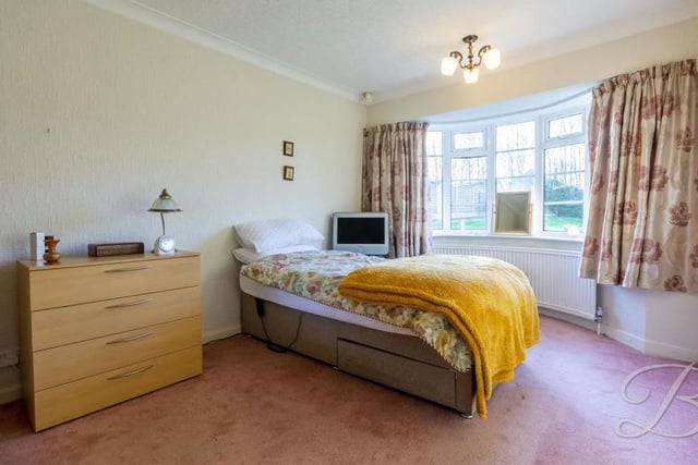We're moving across the inner hallway now to find the largest bedroom. A comfortable space, it boasts a carpeted floor, a central heating radiator and a grand bay window to the front of the property.