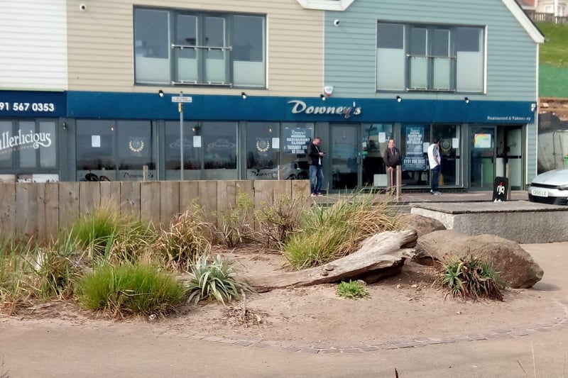 Residents keep their distance while they queue for their fish and chips outside Downey's.
