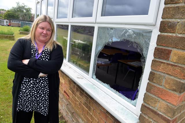 Hastings Hill Academy headteacher Natalie Foundation at the smashed window caused by vandals.