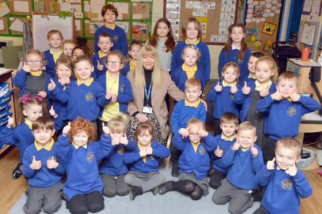 Westlea Primary School children join headteacher Debbie Hughes in giving a thumbs up to their good Ofsted report.