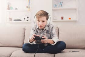 While the online gaming community can help young people to stay connected with friends, it can bring some risks.​​​​​​​ Photo posed by model