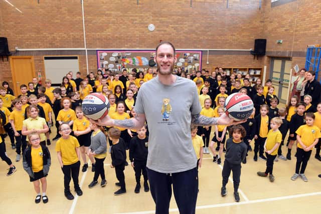 At 7ft 7.26 inches tall, Paul towers above the primary school children of Fatfield Academy.