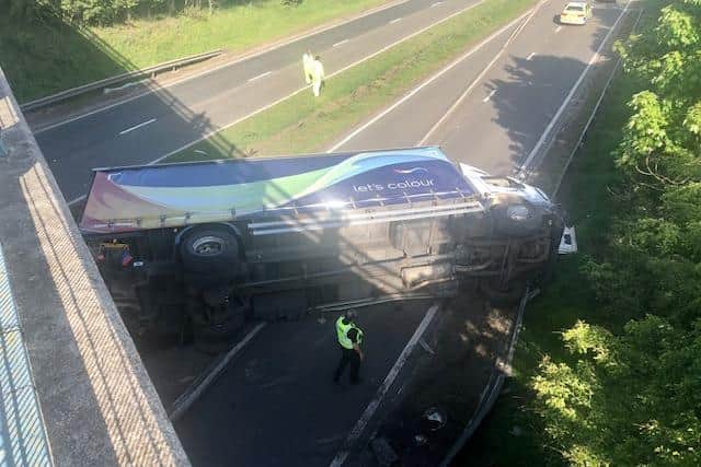 The lorry crashed through the central reservation before overturning. Photo: Paul Blakelock