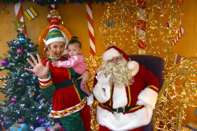 Santa Claus and his Elf with Ava Hutchinson, 17 months being the first to meet Santa at The Bridges.