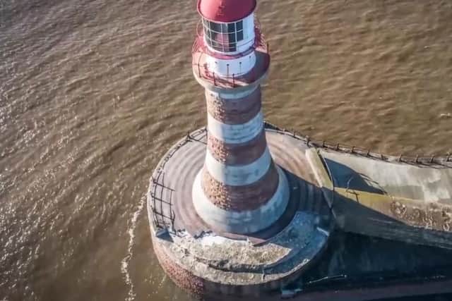 Railings and paving were ripped out from the area around the base of Roker Lighthouse. Image from Brian Priest.