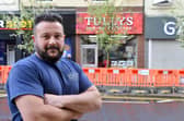 Grant Tully says the growing trees outside his premises are bad for the business. Picture by Stu Norton.