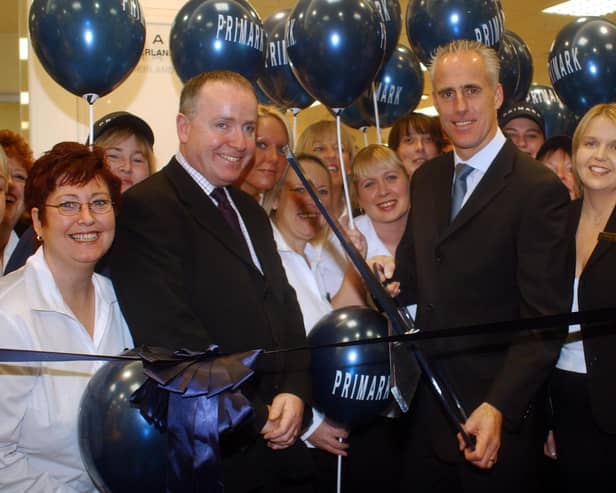 Former Sunderland manager Mick McCarthy cut the ribbon to open the new shop with staff looking on.