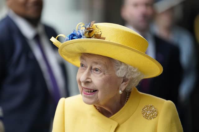Queen Elizabeth II at Paddington station in London, to mark the completion of London's Crossrail project and, no doubt, the yellow hat is a nod to her new pudding.