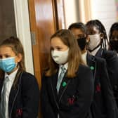 With children being sent home from school due to cases of Coronavirus, what should parents do if their children are sent home because somebody else has tested positive? (Photo by OLI SCARFF/AFP via Getty Images)