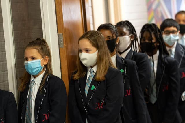 With children being sent home from school due to cases of Coronavirus, what should parents do if their children are sent home because somebody else has tested positive? (Photo by OLI SCARFF/AFP via Getty Images)