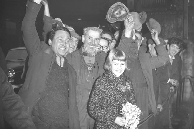A cheer from shipyard workers for 10 year old Lisa Steincke after she launched the 1,800 ton cargo carrier Baltic Vanguard from the Pallion, Sunderland shipyard of Willam Doxford and Sons (Shipbuilders), in January 1966.