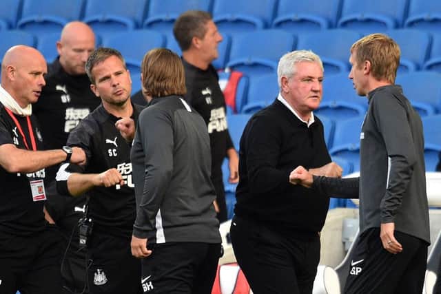 Steve Bruce, Manager of Newcastle United interacts with Graham Potter, Manager of Brighton and Hove Albion at full-time after the Premier League match between Brighton & Hove Albion and Newcastle United at American Express Community Stadium on July 20, 2020 in Brighton, England.
