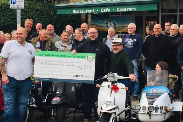 Chris Thornton, sitting on the white scooter with daughter Molly in the sidecar, at the GNAAS cheque presentation in Whitburn.