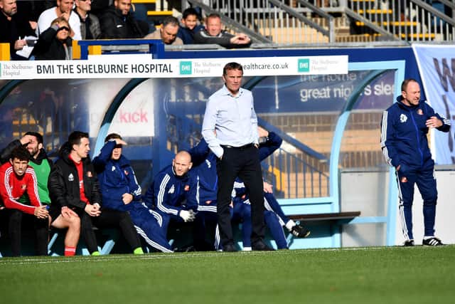 Phil Parkinson takes charge of his first game at Wycombe Wanderers one year ago