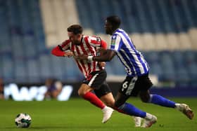 Sunderland's Patrick Roberts (left) and Sheffield Wednesday's Dominic Iorfa battle for the ball during the Carabao Cup, first round match at Hillsborough.