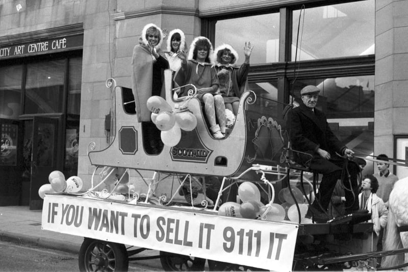 Scotsman Publications Tele-adds staff on the back of a float in Market Street (outside the newspaper's Edinburgh office) to promote advertising in the TSPL papers in December 1986.