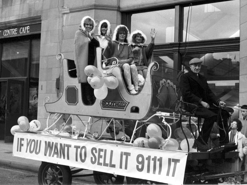 Scotsman Publications Tele-adds staff on the back of a float in Market Street (outside the newspaper's Edinburgh office) to promote advertising in the TSPL papers in December 1986.